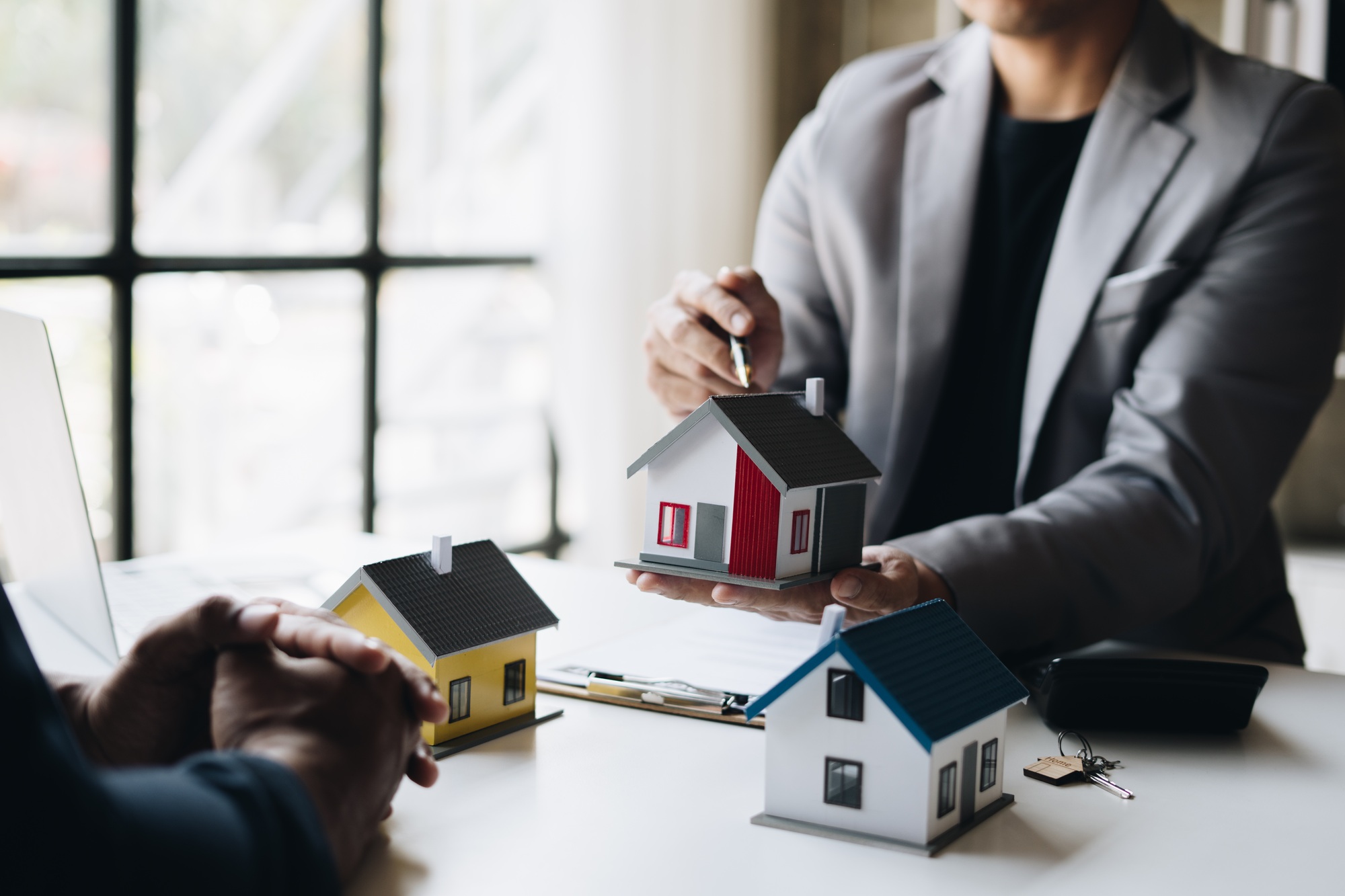 Real-estate agent talking with his customer. moving home or renting property.